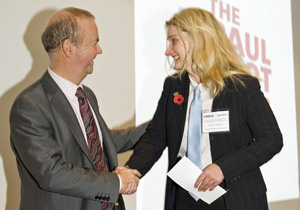 Photo of Clare Sambrook receiving the Paul Foot award from Private Eye editor Ian Hislop